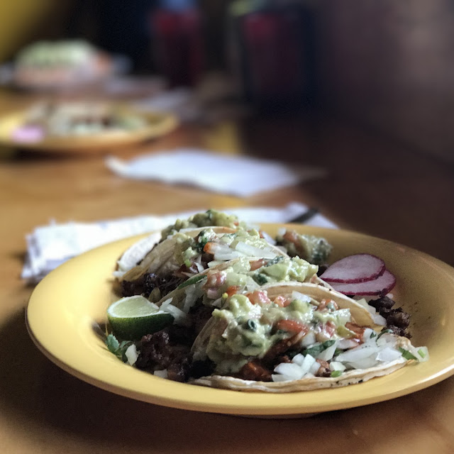 Tacos topped with fresh guacamole at Zamorana
